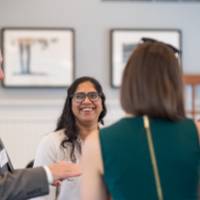 Faculty talking and smiling